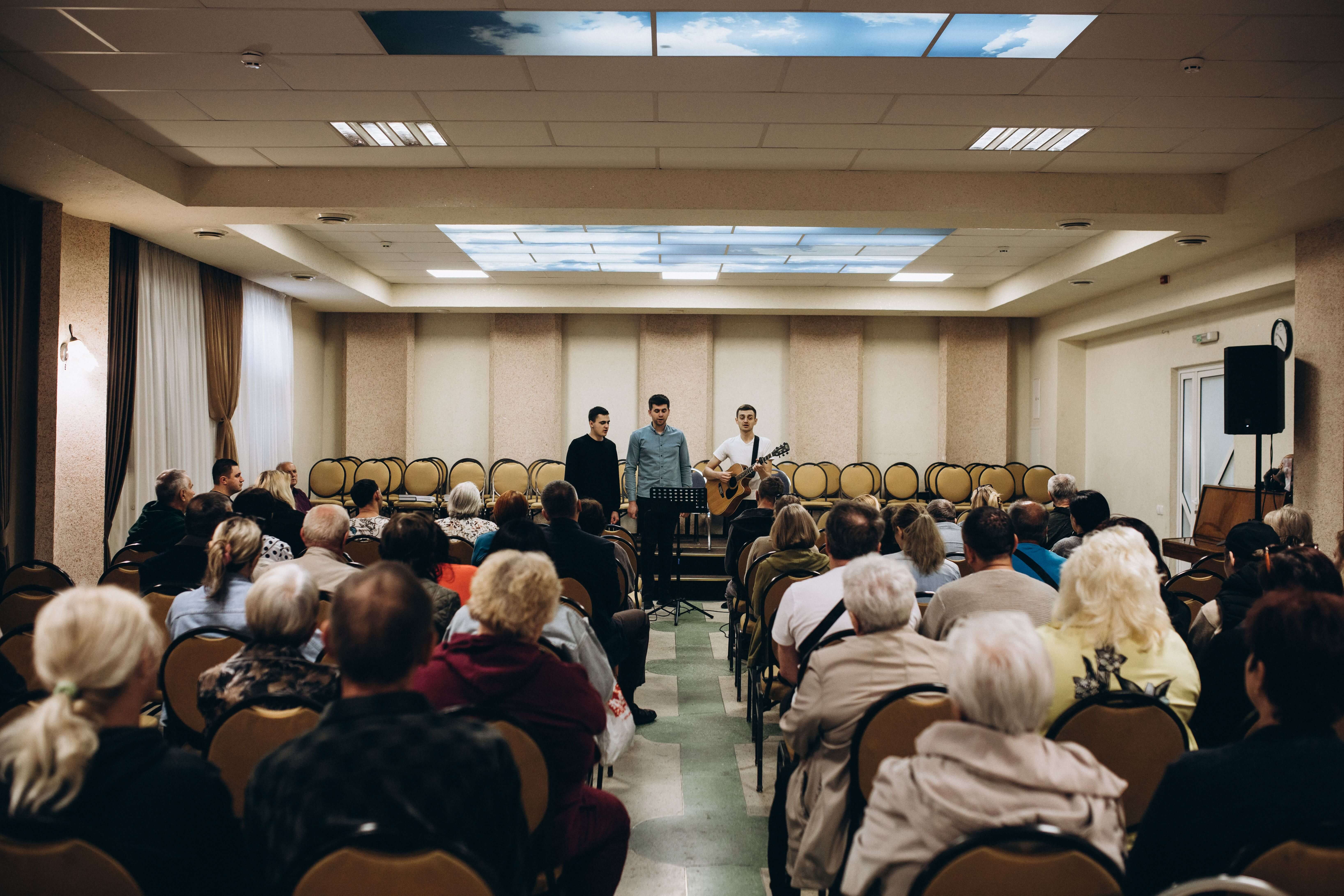 Ukrainian refugees enjoy a break from the darkness of war and listen to worship in Rivne, Ukraine